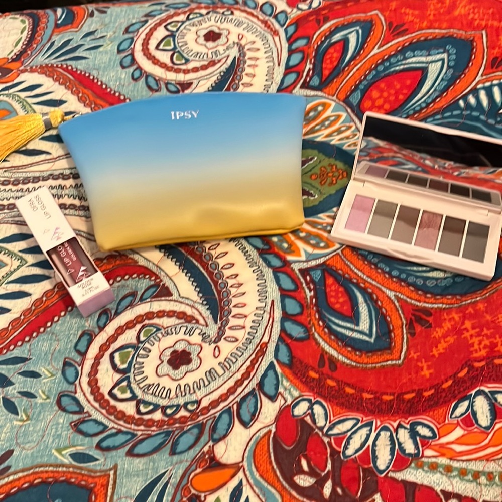 Ipsy bag with eyeshadow palette and lip gloss never used.